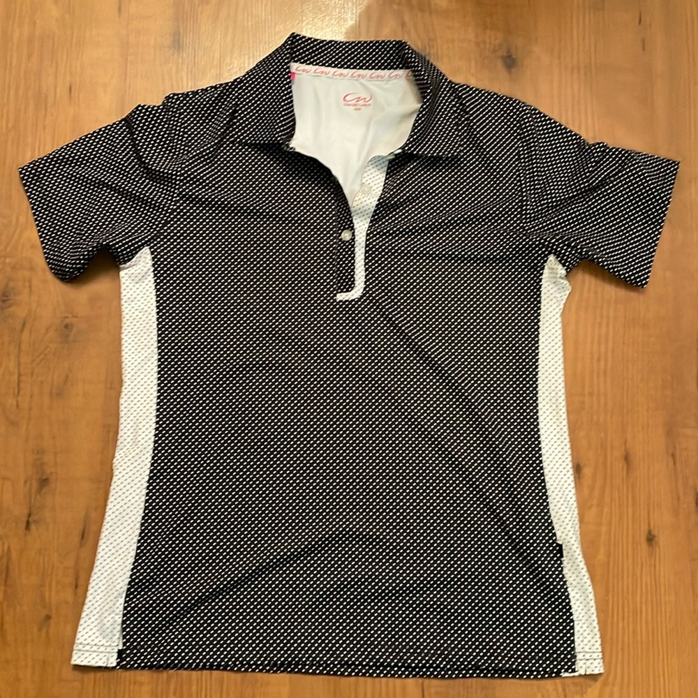 Cracked Wheat black and white polka dotted golf shirt.
